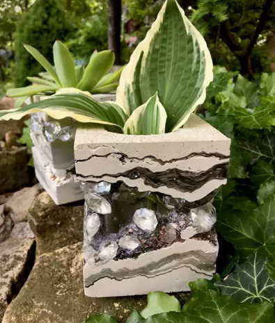 A unique and layered concrete and jewel vases 