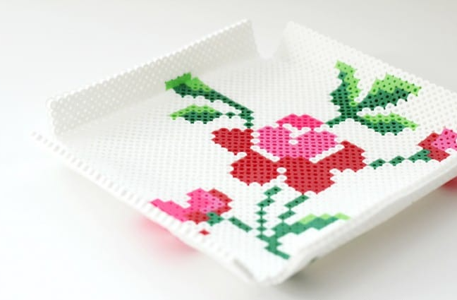 Perler bead tray with a vintage rose design on it