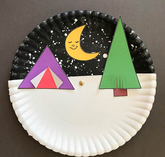 A paper plate that has a night camping scene painted on it