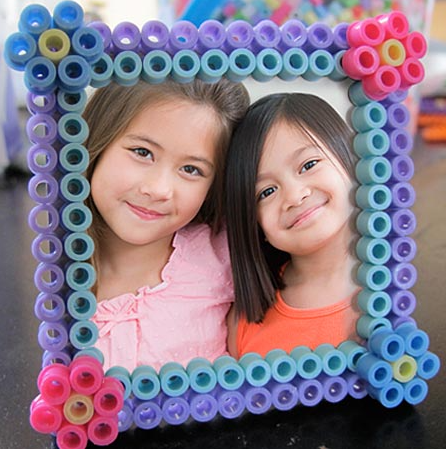 Perler bead picture frame that has a photo of two adorable kids on it