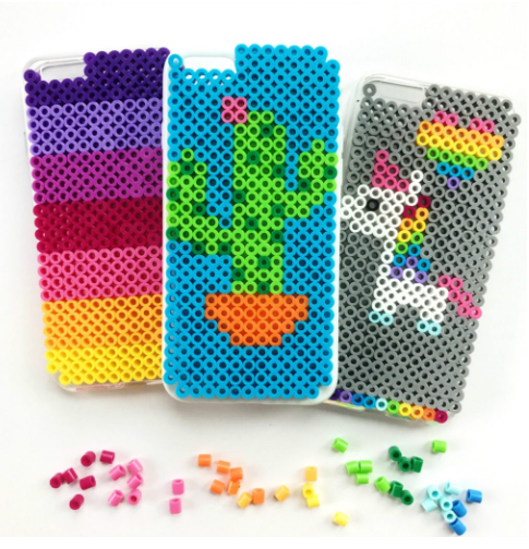 Three perler beads Iphone cases; one has a cactus design on it, second has a unicorn and a heart design on it and the third one has different colors perler bead design