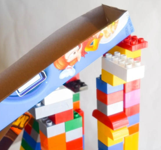 Cereal box ramps on top of Legos a hands on STEM activity