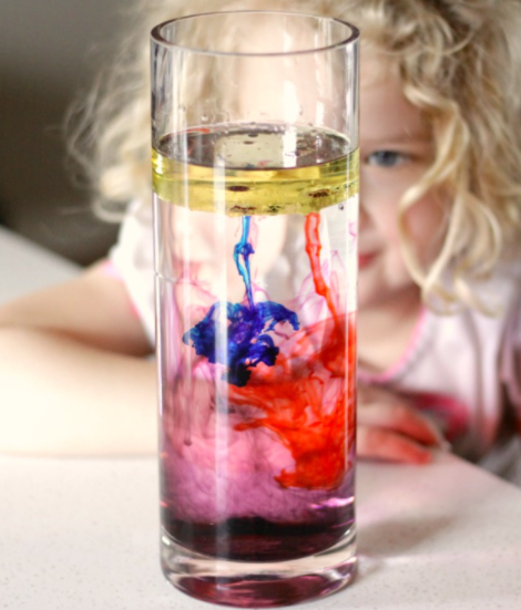 Mixed of oil, water and blue and red food coloring on a glass 