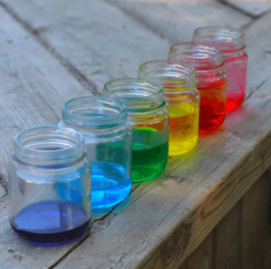 Water on a jar that has different colors like a rainbow