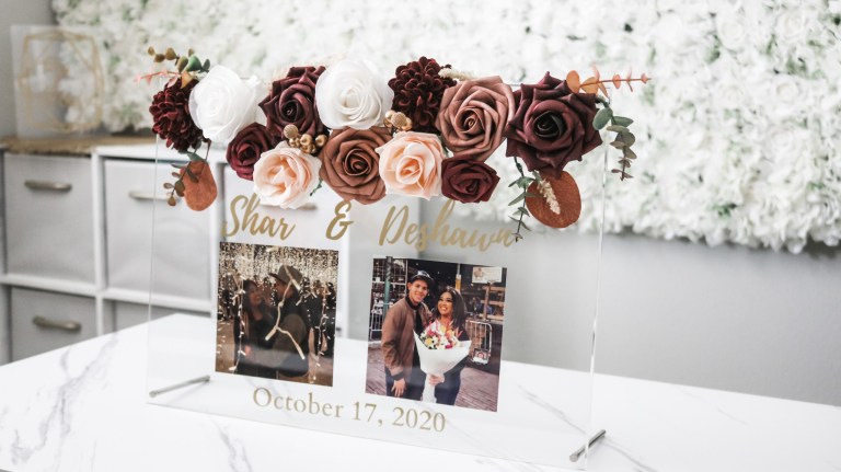 Beautiful acrylic wedding sign with the bride and groom name and photos and the wedding date