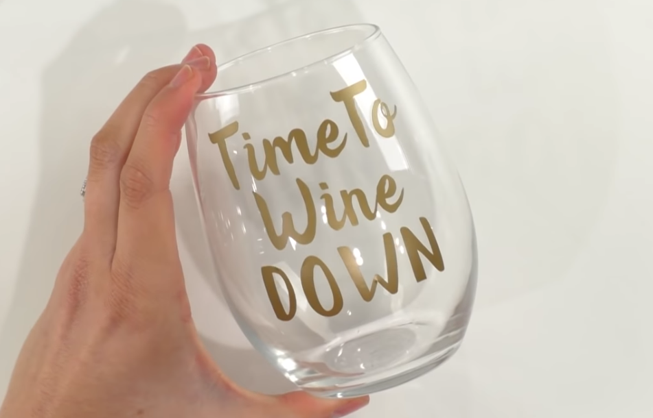 A simple wine glass perfect for wedding present that says Time To Wine Down made with a die-cutting machine