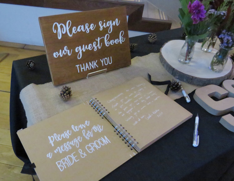 Wooden wedding sign says Please sign our guest book, Thank you.