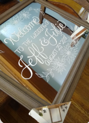 Welcome mirror wedding sign with text saying Welcome to the wedding of Jeff & Julie August 25 2018