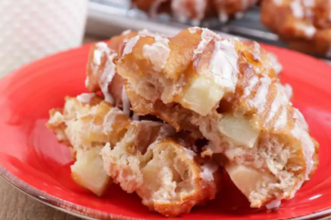 Scrumptious apple fritters drizzled with blended powdered sugar and milk
