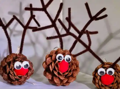 cute little reindeers made from pine cones display for the christmas holiday