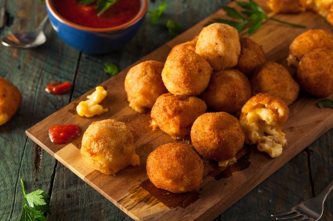 baked mac and cheese bites served with a delicious marinara dipping sauce