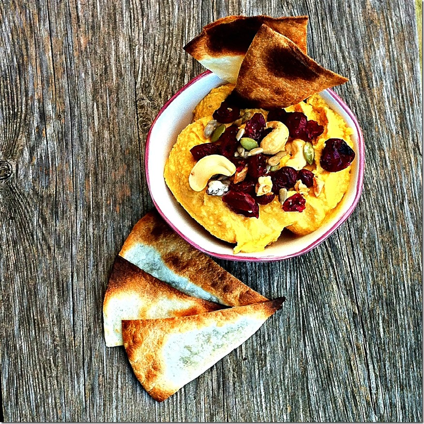 Pumpkin hummus topped with a fall snack mix and tortilla chips