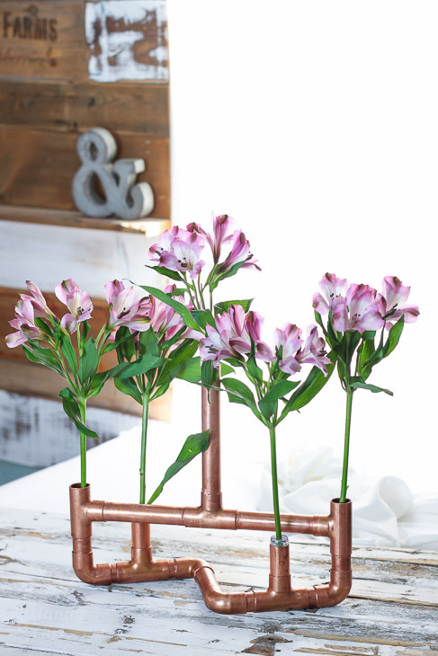 copper pipe centerpiece fill with beautiful flowers