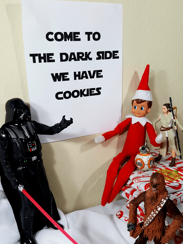 elf on the shelf having cookies with star wars dark vader