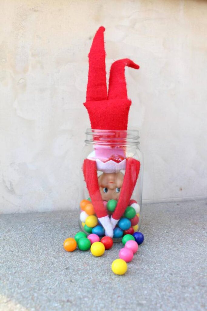 ELF ON THE SHELF UPSIDE DOWN IN THE GUM BALLS JAR