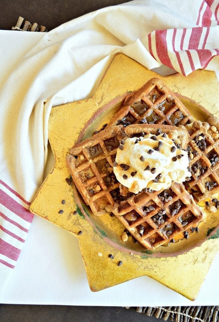 gingerbread eggnog waffles studded with toasted pecans and top with whipped cream and maple syrup