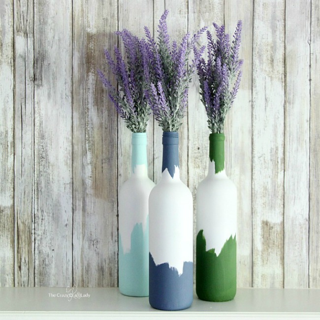 Painted decorative wine bottle vase for a simple centerpiece.