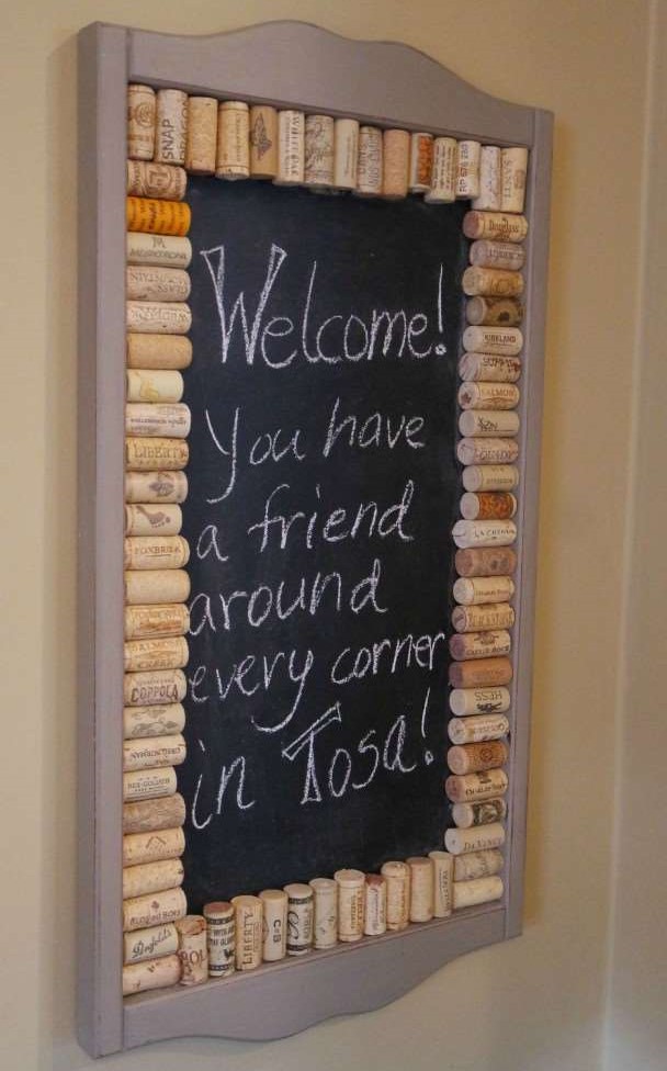 Wine cork chalkboard with a text on it saying Welcome! You have a friend around every corner in Tosa!