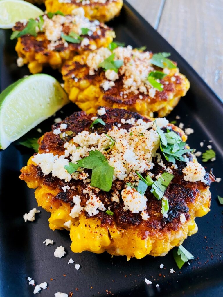 Blackstone street corn fritters topped with more cilantro and cotija cheese