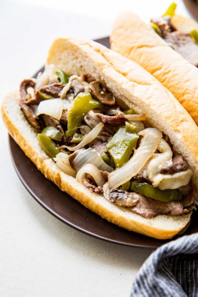 Sheet Pan Philly Cheese Steak Tender meat, flavorful peppers, onions, and mushrooms, and cheese in 30 minutes