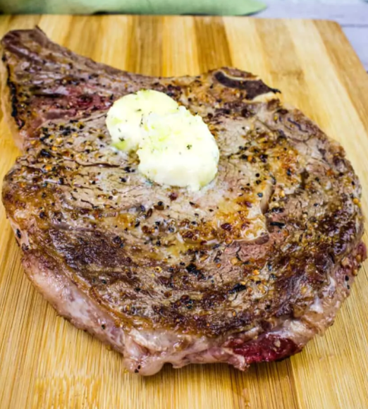 Steak with a tablespoon of delish herb butter on top