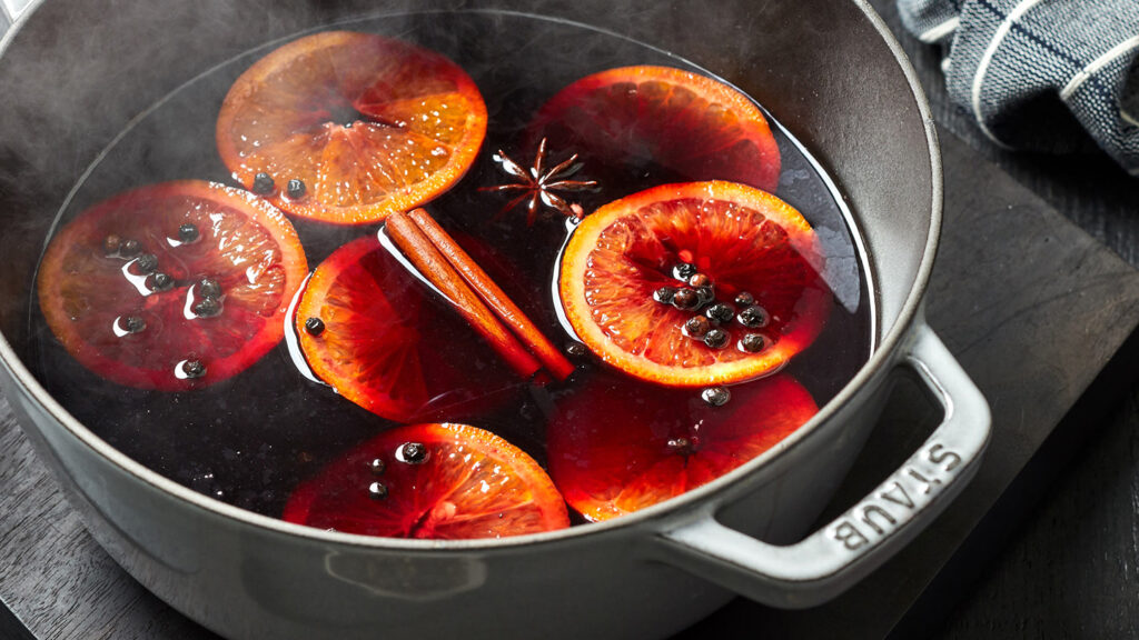 Sweet and spicy mulled wine garnished with orange slices and cinnamon sticks