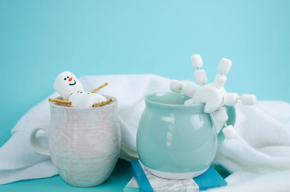 adorable marshmallow snowman and snowflake on a cup of hot chocolate