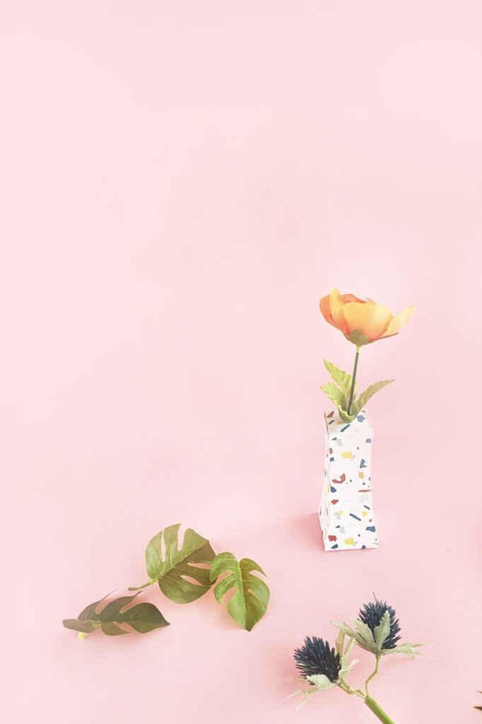 Terrazzo Paper Vase with fake flowers and fake leaves on it
