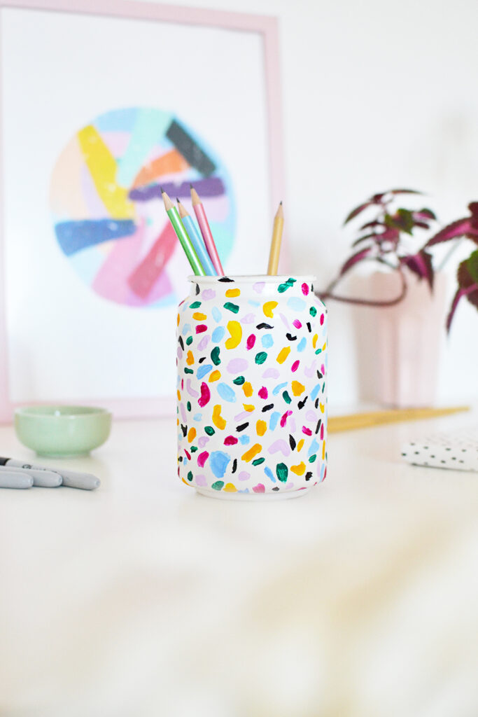 Colorful terrazzo pencil holder with pens on it