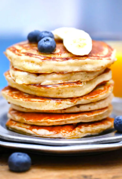 fluffy and filling Greek Yogurt Pancakes topped with fresh fruits and maple syrup for breakfast