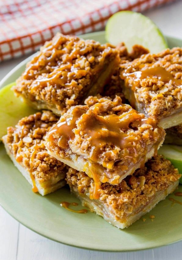 homemade salted caramel apple pie bars drizzled with some salted caramel sauce on top