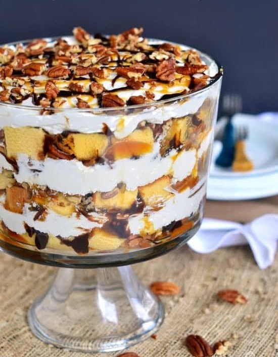 Turtle Cheesecake Trifle filled with layers of caramel, chocolate, pecans, no bake cheesecake, and pound cake
