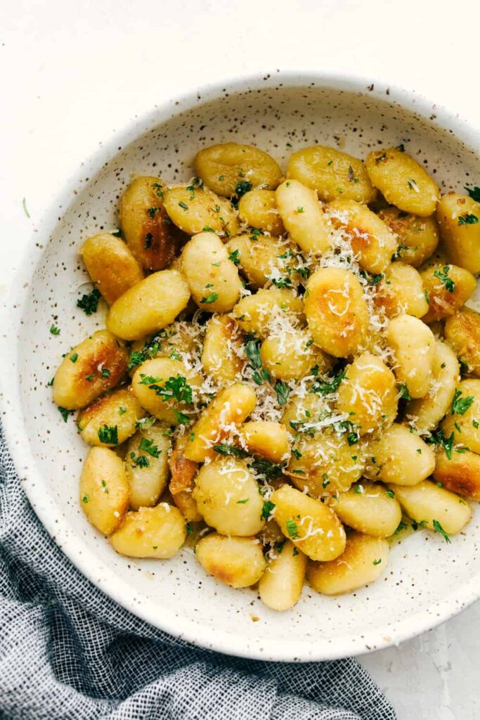 Brown Butter Garlic Fried Gnocchi topped with parmesan cheese