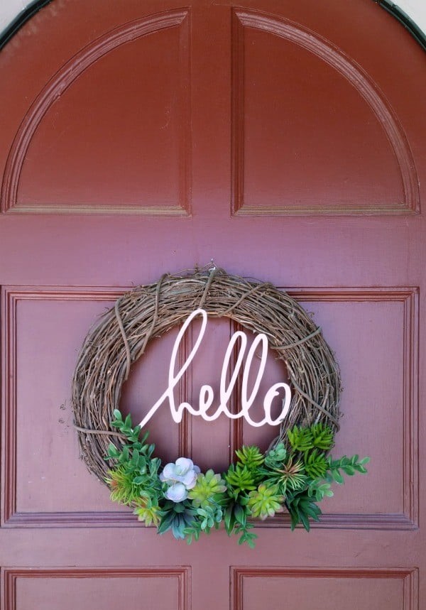 DIY Faux Succulent Wreath has a word hello at the middle of the wreath