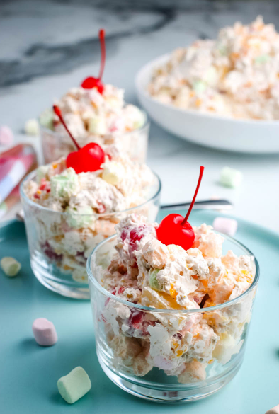 ambrosia fruit salad with Cool Whip, sour cream, fruit, and mini marshmallows