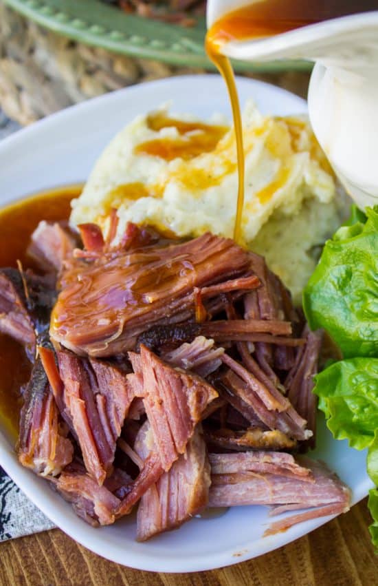 Slow cooker easy sriracha ham with mashed potato and gravy on the side