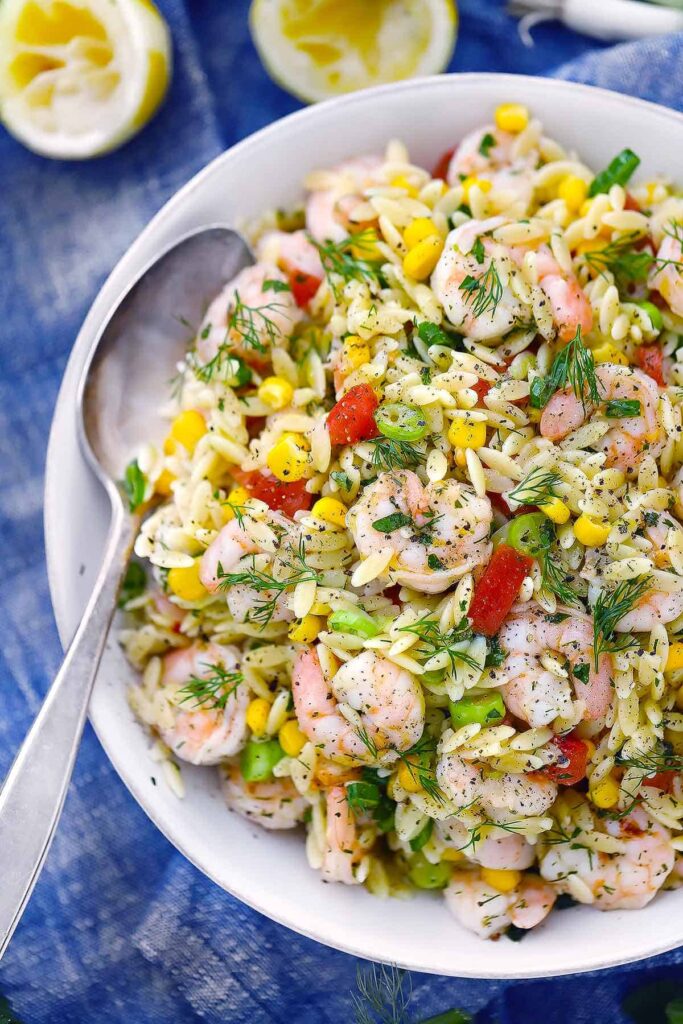 Shrimp and Orzo Salad garnished with extra herbs and olive oil