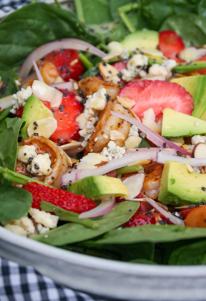  Spinach Strawberry Salad is topped with shrimp, avocado, almond, onions, and a lite poppy seed dressing