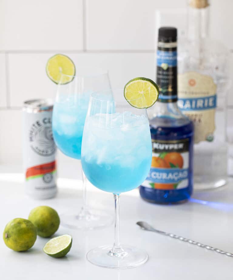 Drunken Mermaid a refreshing, blue cocktail made with vodka, Blue Curacao, syrup, lime juice, and flavored spiked sparkling water perfect for summer