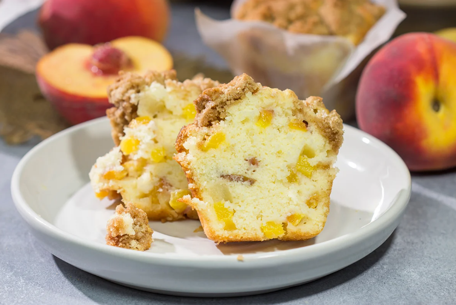 Peach Streusel Muffins topped with brown sugar crumble