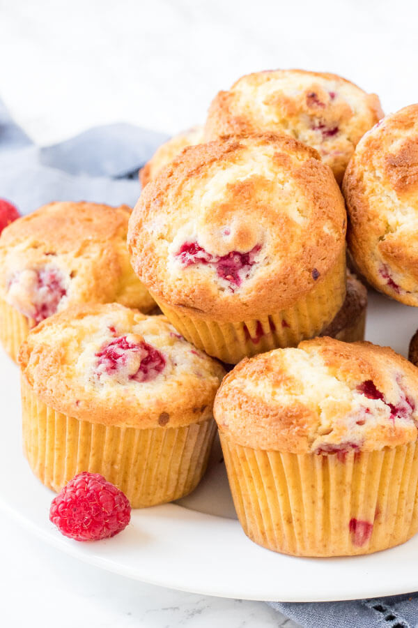 Fluffy raspberry muffins moist and filled with sweet, juicy berries