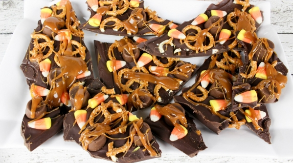 Addictive candy corn chocolate bark drizzled with melted caramel all over the top of the chocolate bark