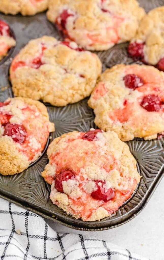 cherry cobbler muffins topped with a crumbly, sweet streusel