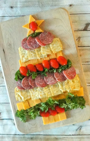 Christmas tree cheese platter with sausage and crackers