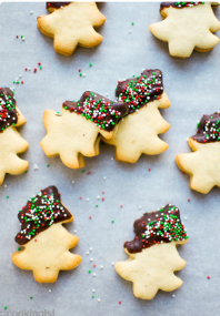 chocolate dipped Christmas tree cookies topped with holiday sprinkles
