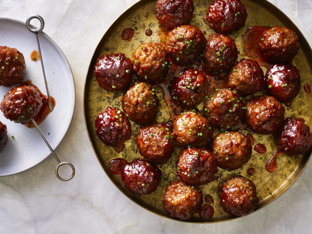 Slow-Cooker Grape Jelly Meatballs top with chives before serving 