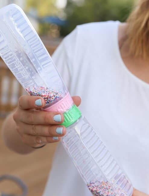 Bottle to bottle baby shower game. Players must transfer sprinkles from one bottle to the other bottle to win