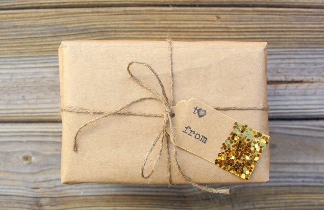 Brown paper package with glitter dipped gift tags