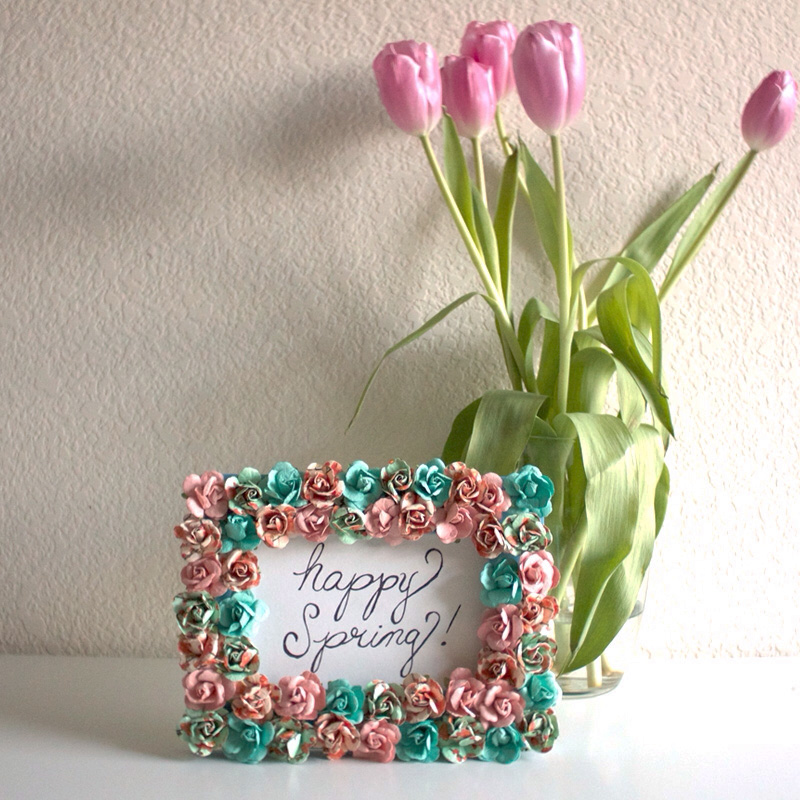 Lovely floral frame has a text on it saying happy spring!