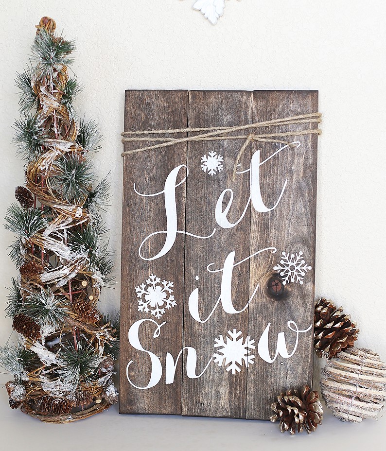 beautiful rustic woodland winter sign that says Let It Snow